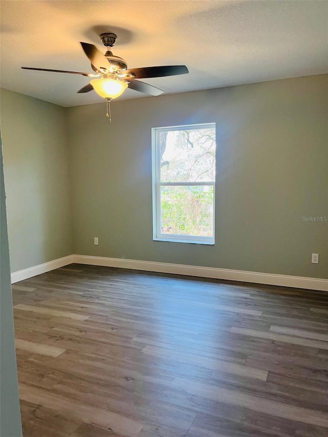 1329 Tom Watson Rd, Lakeland, FL 33801 - spare room featuring wood finished floors, baseboards, ceiling fan, and a textured ceiling