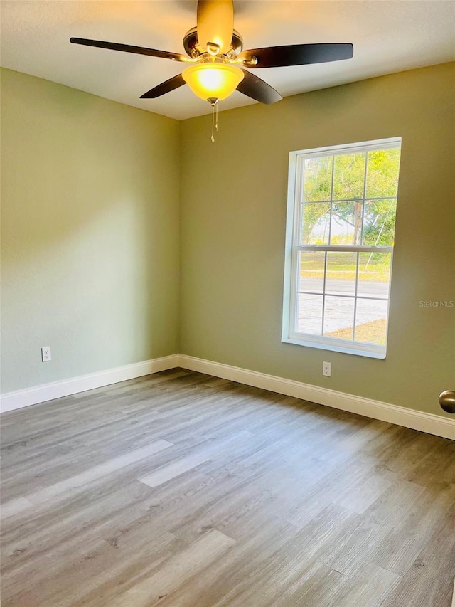 1329 Tom Watson Rd, Lakeland, FL 33801 - empty room with ceiling fan, wood finished floors, and baseboards
