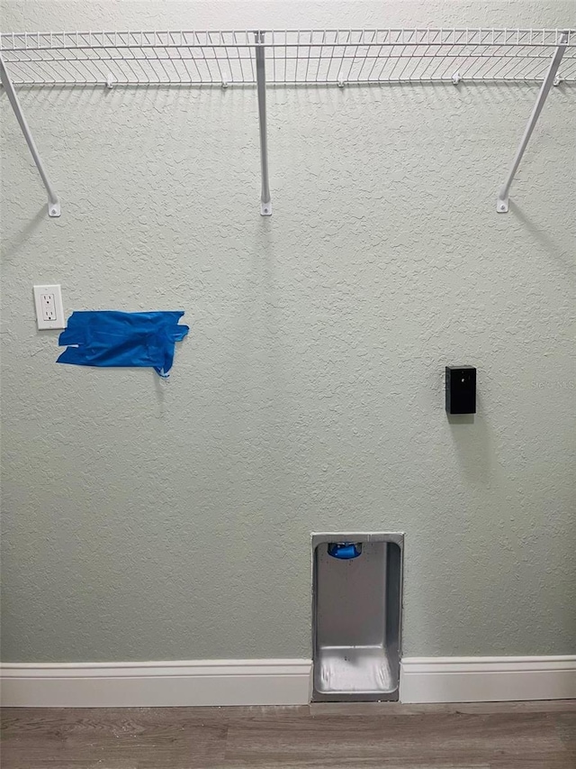 1329 Tom Watson Rd, Lakeland, FL 33801 - laundry area with wood finished floors and baseboards