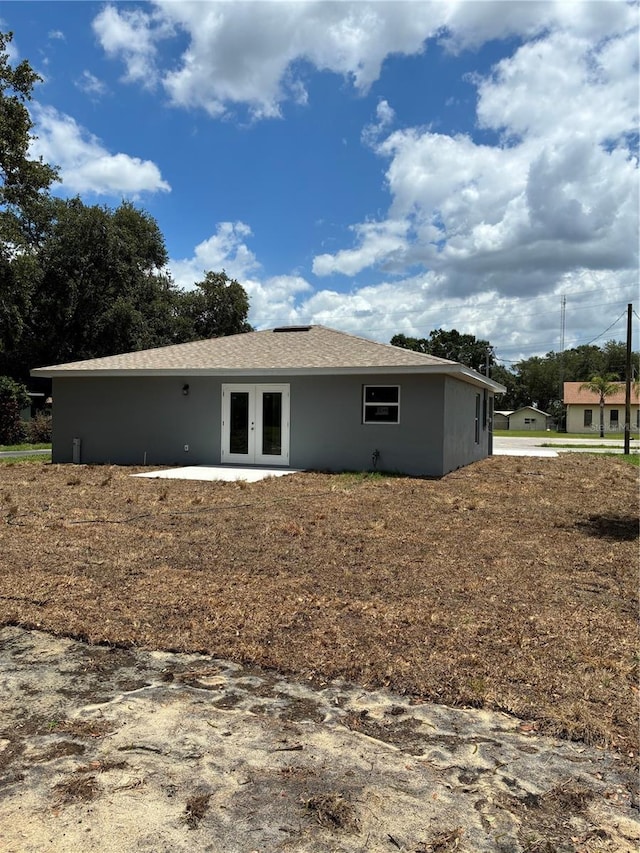 1329 Tom Watson Rd, Lakeland, FL 33801 - rear view of house with french doors and stucco siding