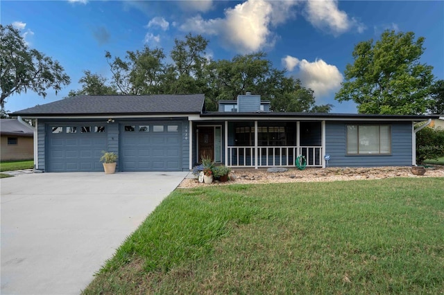1920 Indian Trails Ct, Lakeland, FL 33813 - ranch-style house with a garage, a front lawn, concrete driveway, a chimney, and a porch