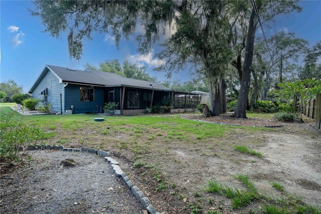 1920 Indian Trails Ct, Lakeland, FL 33813 - rear view of property featuring a sunroom and a yard