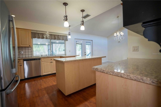 1920 Indian Trails Ct, Lakeland, FL 33813 - kitchen featuring stainless steel appliances, vaulted ceiling, dark wood-type flooring, french doors, and a sink