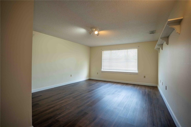 1920 Indian Trails Ct, Lakeland, FL 33813 - spare room featuring a textured ceiling, dark wood finished floors, and baseboards