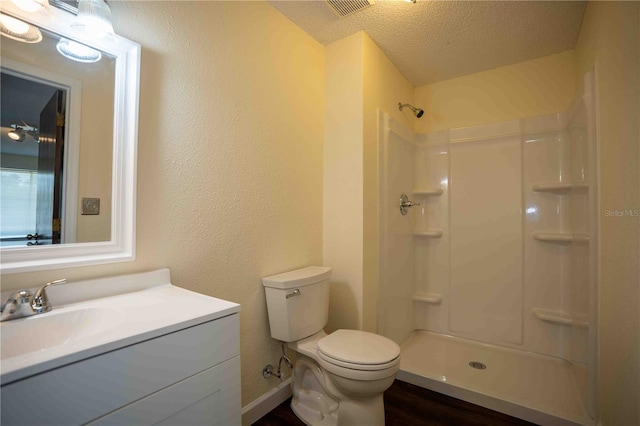 1920 Indian Trails Ct, Lakeland, FL 33813 - full bath with toilet, a shower, wood finished floors, vanity, and a textured ceiling