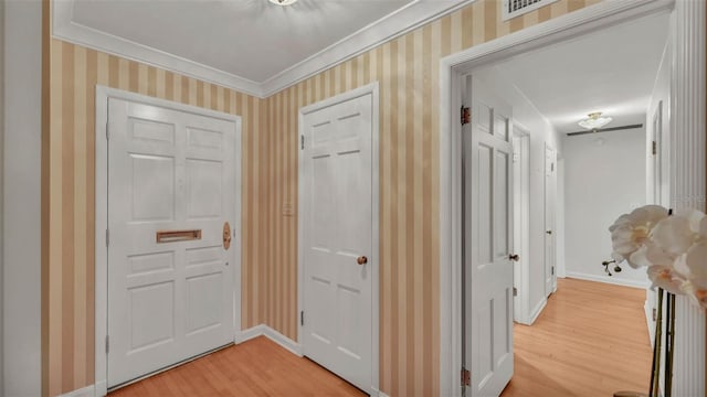 323 E Belvedere St, Lakeland, FL 33803 - corridor featuring light wood-style flooring, crown molding, wallpapered walls, and baseboards