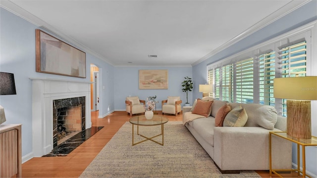 323 E Belvedere St, Lakeland, FL 33803 - living room with wood finished floors, a fireplace, crown molding, and baseboards