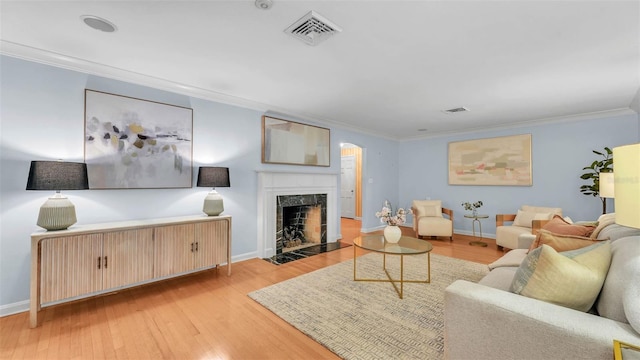323 E Belvedere St, Lakeland, FL 33803 - living area with light wood-style flooring, ornamental molding, baseboards, and a high end fireplace