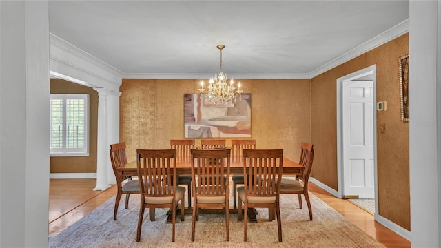 323 E Belvedere St, Lakeland, FL 33803 - dining area with a chandelier, wood finished floors, crown molding, baseboards, and decorative columns