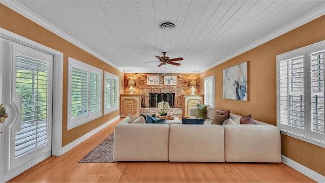 323 E Belvedere St, Lakeland, FL 33803 - living area featuring crown molding, a fireplace, ceiling fan, wood finished floors, and baseboards