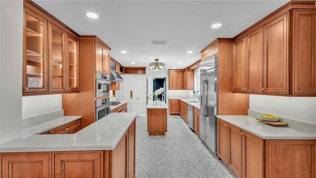 323 E Belvedere St, Lakeland, FL 33803 - kitchen featuring brown cabinetry, recessed lighting, appliances with stainless steel finishes, glass insert cabinets, and a peninsula