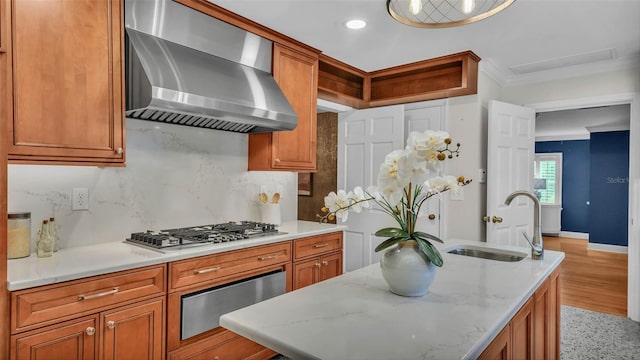 323 E Belvedere St, Lakeland, FL 33803 - kitchen featuring wall chimney exhaust hood, a sink, stainless steel gas stovetop, a warming drawer, and brown cabinets