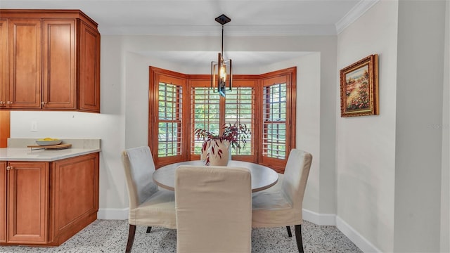 323 E Belvedere St, Lakeland, FL 33803 - dining room featuring dark aggregate flooring, baseboards, a chandelier, and crown molding