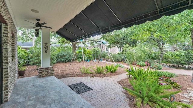 323 E Belvedere St, Lakeland, FL 33803 - view of patio / terrace featuring a playground and ceiling fan