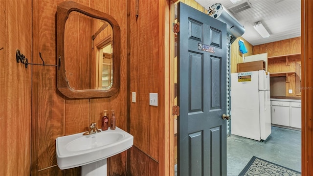 323 E Belvedere St, Lakeland, FL 33803 - bathroom featuring concrete floors, a sink, and wood walls