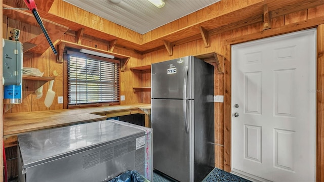 323 E Belvedere St, Lakeland, FL 33803 - kitchen with freestanding refrigerator, open shelves, wooden walls, and wood counters