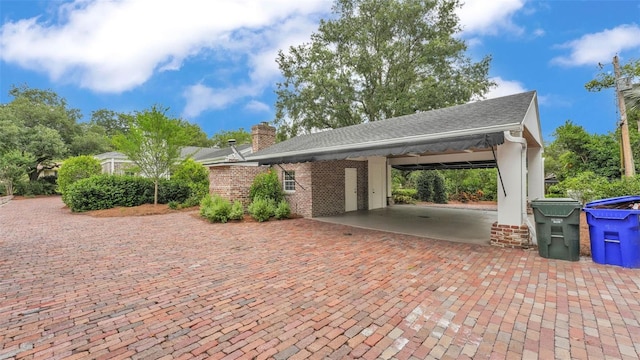 323 E Belvedere St, Lakeland, FL 33803 - view of parking / parking lot featuring an attached carport