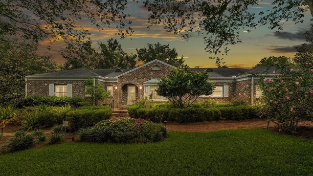 323 E Belvedere St, Lakeland, FL 33803 - view of front of home with a front lawn, brick siding, and a chimney