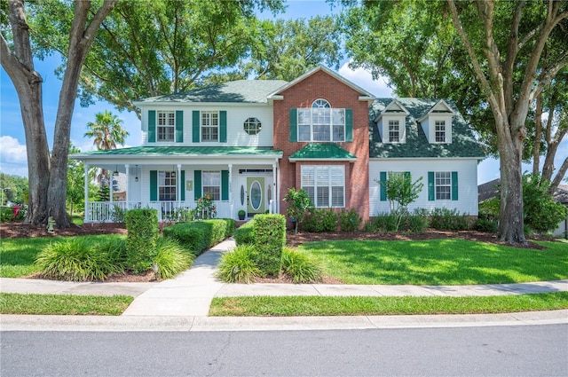 5425 Charlin Ave, Lakeland, FL 33810 - view of front of home featuring covered porch and a front lawn