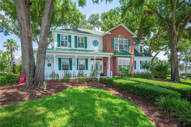 5425 Charlin Ave, Lakeland, FL 33810 - view of front of house featuring covered porch, brick siding, and a front yard