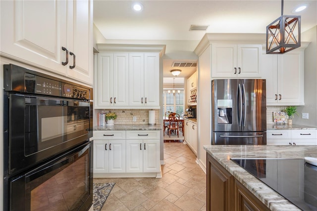 5425 Charlin Ave, Lakeland, FL 33810 - kitchen with black appliances, recessed lighting, backsplash, light stone counters, and white cabinetry