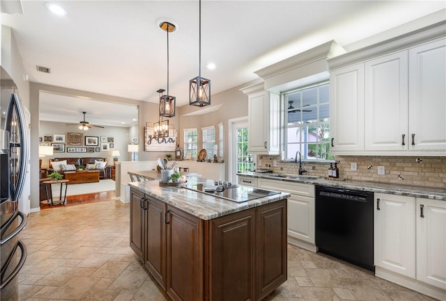 5425 Charlin Ave, Lakeland, FL 33810 - kitchen featuring black appliances, a sink, stone tile floors, backsplash, and recessed lighting