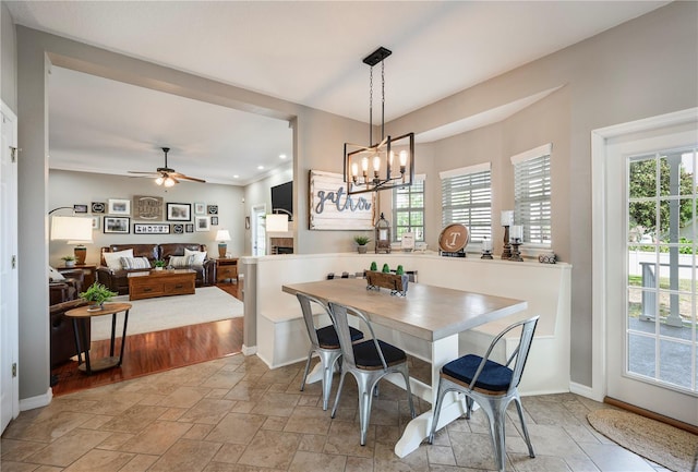 5425 Charlin Ave, Lakeland, FL 33810 - dining room featuring ceiling fan, a chandelier, light stone finish flooring, recessed lighting, and baseboards