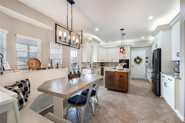 5425 Charlin Ave, Lakeland, FL 33810 - dining room with light stone finish flooring, a chandelier, and recessed lighting