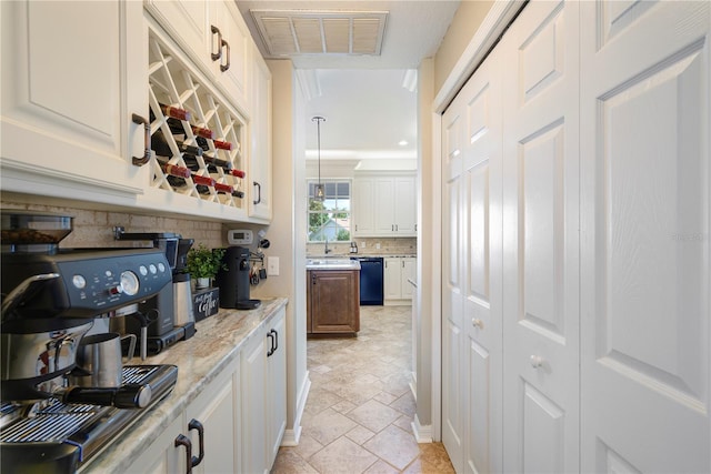 5425 Charlin Ave, Lakeland, FL 33810 - bar area with black dishwasher, stone tile floors, backsplash, pendant lighting, and a sink