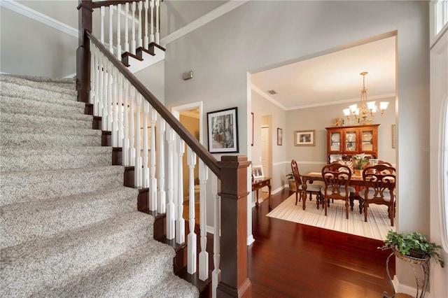 5425 Charlin Ave, Lakeland, FL 33810 - staircase with wood-type flooring, a chandelier, ornamental molding, and baseboards