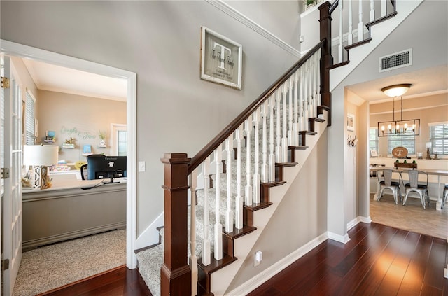 5425 Charlin Ave, Lakeland, FL 33810 - staircase with hardwood / wood-style floors, a chandelier, and baseboards
