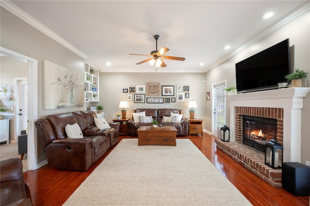 5425 Charlin Ave, Lakeland, FL 33810 - living area featuring a ceiling fan, wood finished floors, a fireplace, crown molding, and recessed lighting