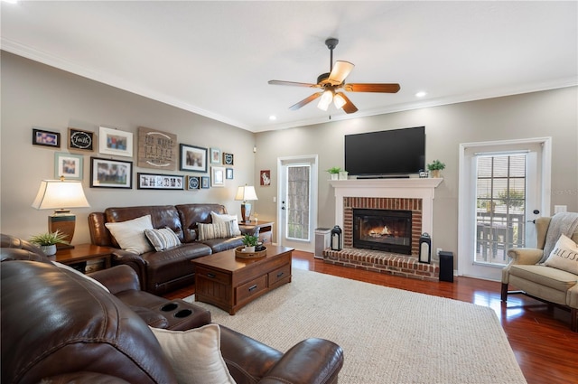 5425 Charlin Ave, Lakeland, FL 33810 - living room with ceiling fan, a fireplace, wood finished floors, ornamental molding, and recessed lighting