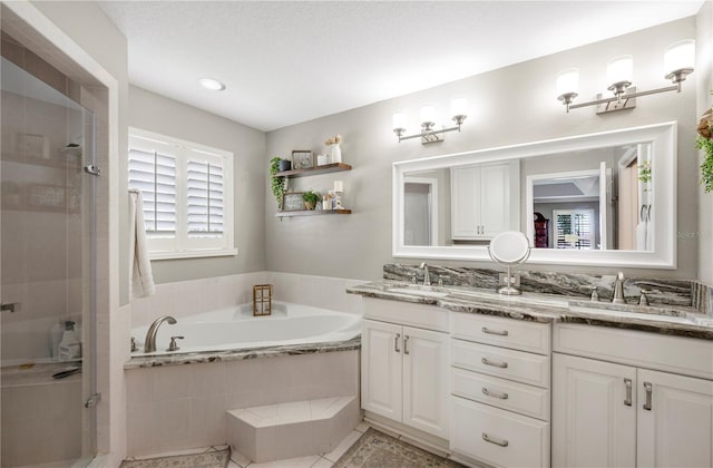 5425 Charlin Ave, Lakeland, FL 33810 - bathroom with double vanity, a stall shower, a bath, tile patterned floors, and recessed lighting
