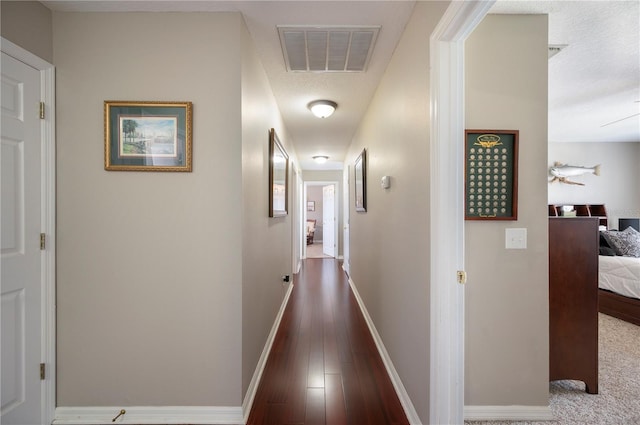 5425 Charlin Ave, Lakeland, FL 33810 - hallway featuring wood finished floors, baseboards, and a textured ceiling