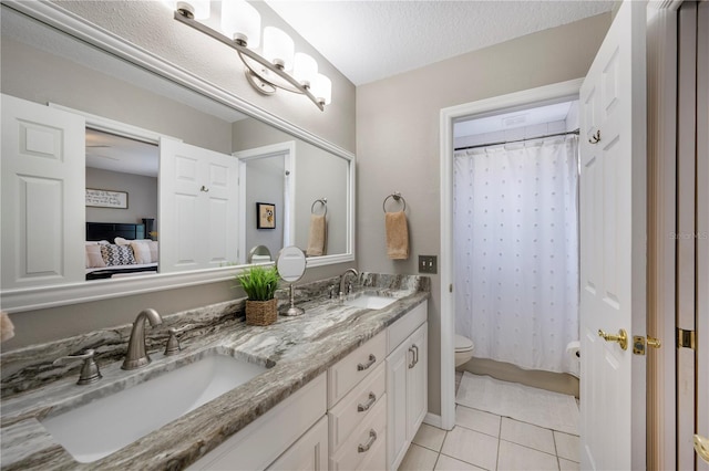 5425 Charlin Ave, Lakeland, FL 33810 - bathroom featuring toilet, double vanity, and tile patterned floors