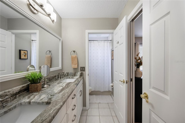 5425 Charlin Ave, Lakeland, FL 33810 - full bath with toilet, double vanity, tile patterned floors, a shower with shower curtain, and a textured ceiling