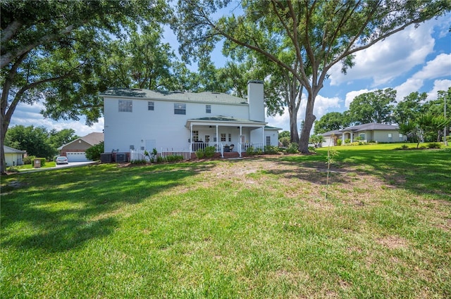 5425 Charlin Ave, Lakeland, FL 33810 - back of house with a chimney and a yard
