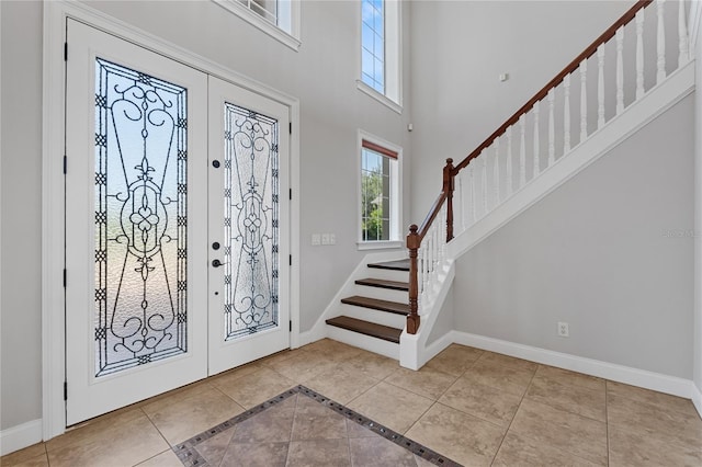 6542 Eagle Ridge Way, Lakeland, FL 33813 - entrance foyer with baseboards, stairs, a high ceiling, and tile patterned flooring