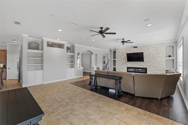 6542 Eagle Ridge Way, Lakeland, FL 33813 - living room featuring built in features, recessed lighting, arched walkways, tile patterned floors, and ceiling fan