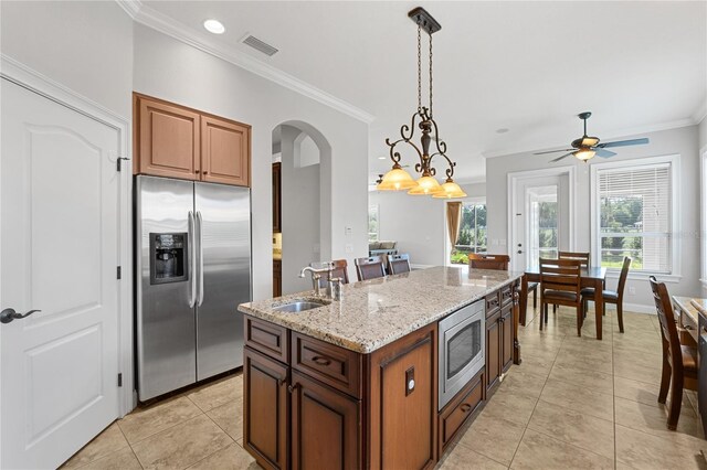 6542 Eagle Ridge Way, Lakeland, FL 33813 - kitchen featuring appliances with stainless steel finishes, a sink, crown molding, light tile patterned flooring, and light stone countertops