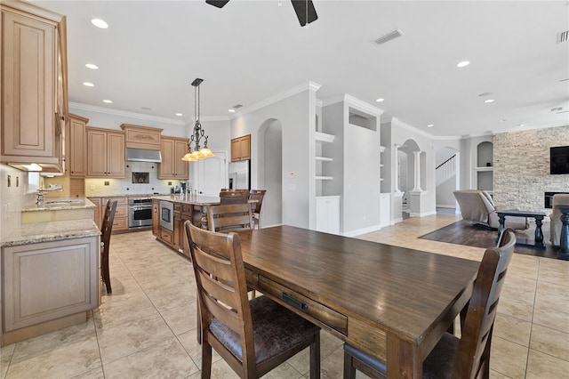 6542 Eagle Ridge Way, Lakeland, FL 33813 - dining space with built in shelves, arched walkways, light tile patterned floors, a ceiling fan, and recessed lighting