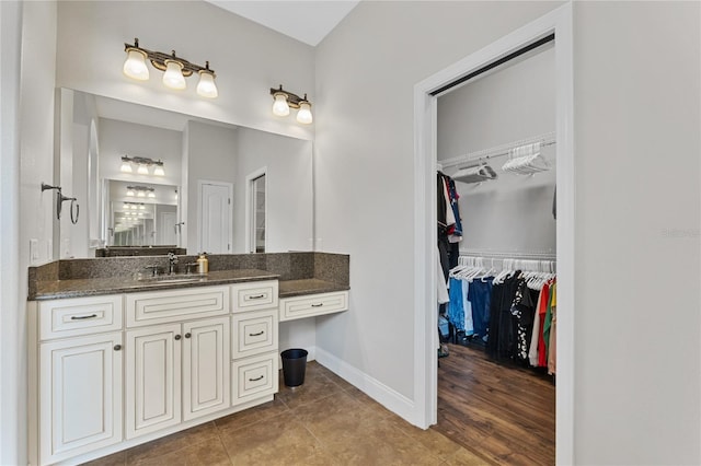 6542 Eagle Ridge Way, Lakeland, FL 33813 - bathroom with vanity, baseboards, a walk in closet, and tile patterned flooring