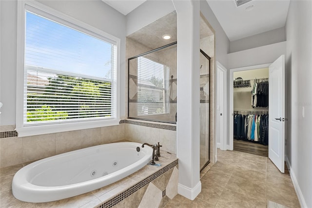 6542 Eagle Ridge Way, Lakeland, FL 33813 - full bath with a tub with jets, a stall shower, a spacious closet, and tile patterned floors
