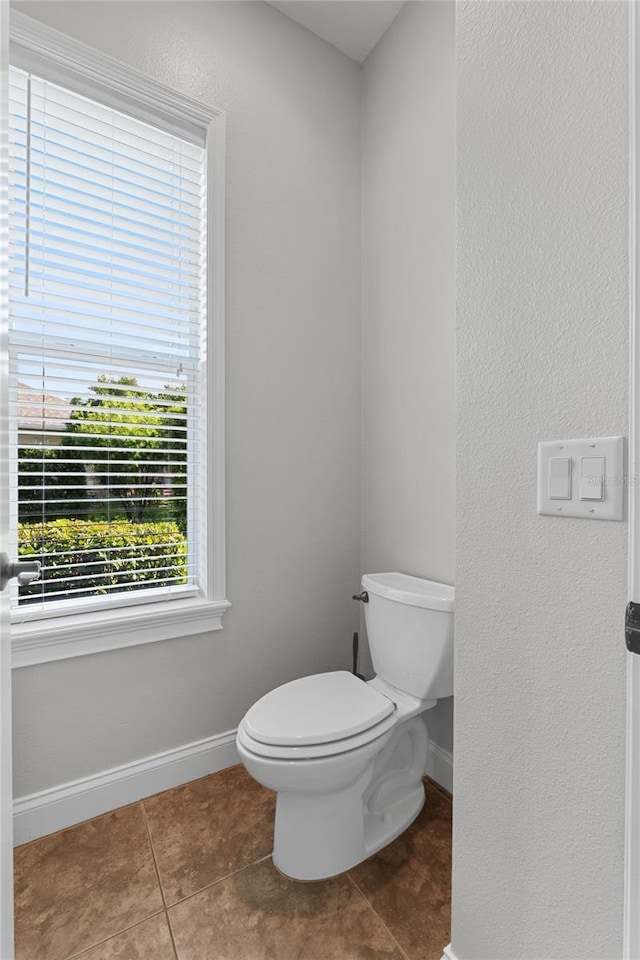 6542 Eagle Ridge Way, Lakeland, FL 33813 - bathroom featuring toilet, tile patterned floors, baseboards, and a textured wall