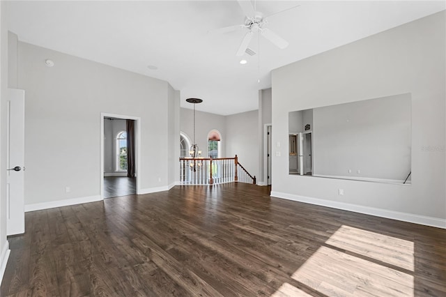 6542 Eagle Ridge Way, Lakeland, FL 33813 - unfurnished living room featuring wood finished floors, a ceiling fan, a chandelier, and baseboards