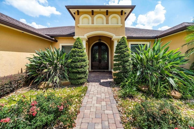 6357 Ashley Dr, Lakeland, FL 33813 - property entrance with french doors and stucco siding
