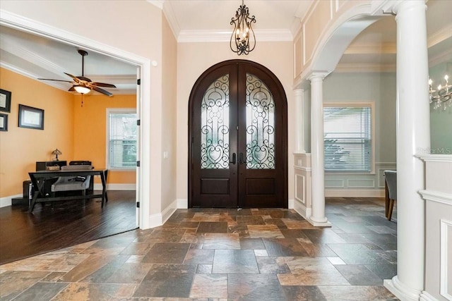 6357 Ashley Dr, Lakeland, FL 33813 - entryway with arched walkways, crown molding, stone tile flooring, and french doors