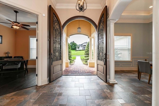 6357 Ashley Dr, Lakeland, FL 33813 - foyer with ornate columns, arched walkways, plenty of natural light, crown molding, and ceiling fan