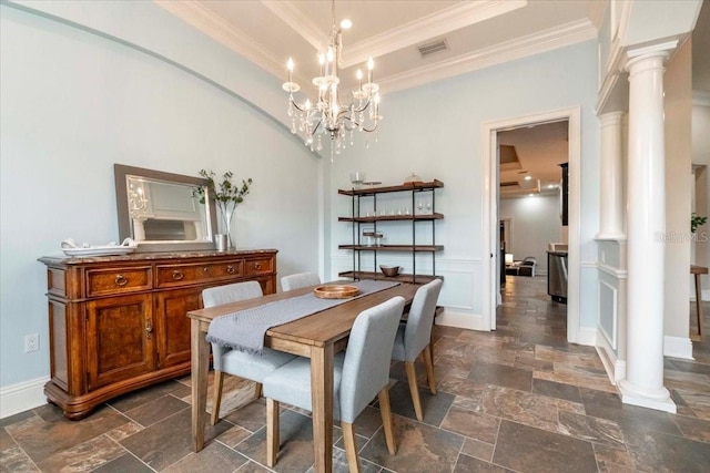 6357 Ashley Dr, Lakeland, FL 33813 - dining space featuring stone tile floors, decorative columns, crown molding, a chandelier, and baseboards